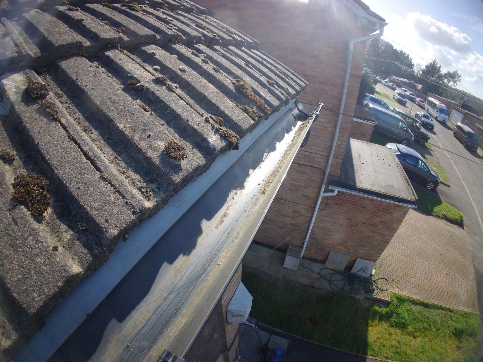 Spotless gutter after professional clearing showing debris-free channel on residential roofline