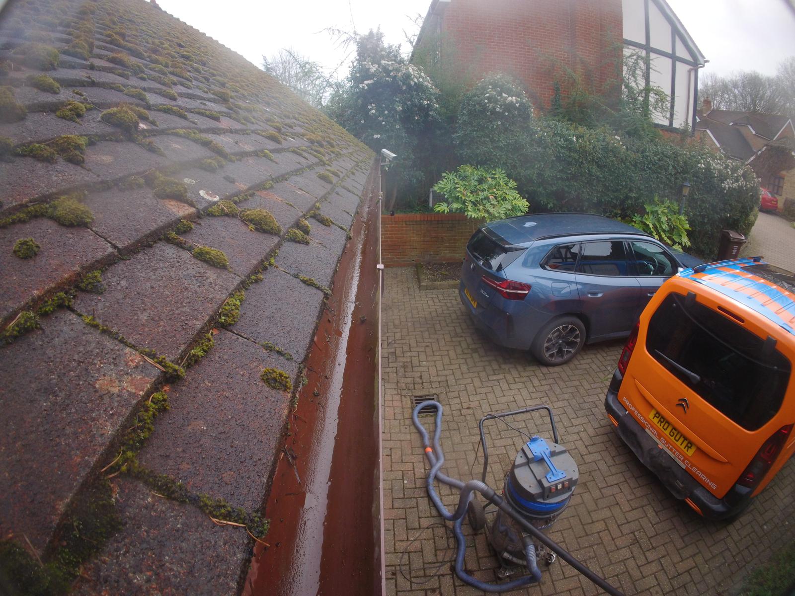 Gutter Pro vacuum system and equipment set up on driveway for ground-based gutter clearing